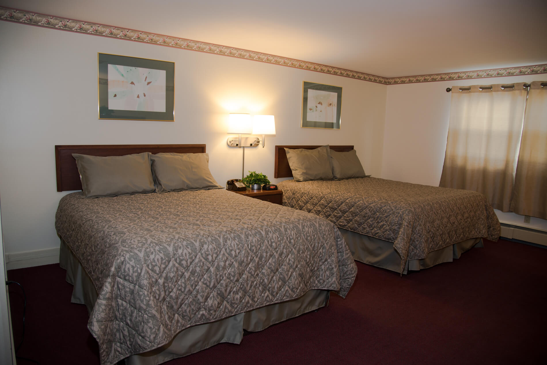 Family Vacation Hotel Close To Hyde Park In Vermont Large Room In Motel With Two Queen Size Beds And Cream Colored Curtains